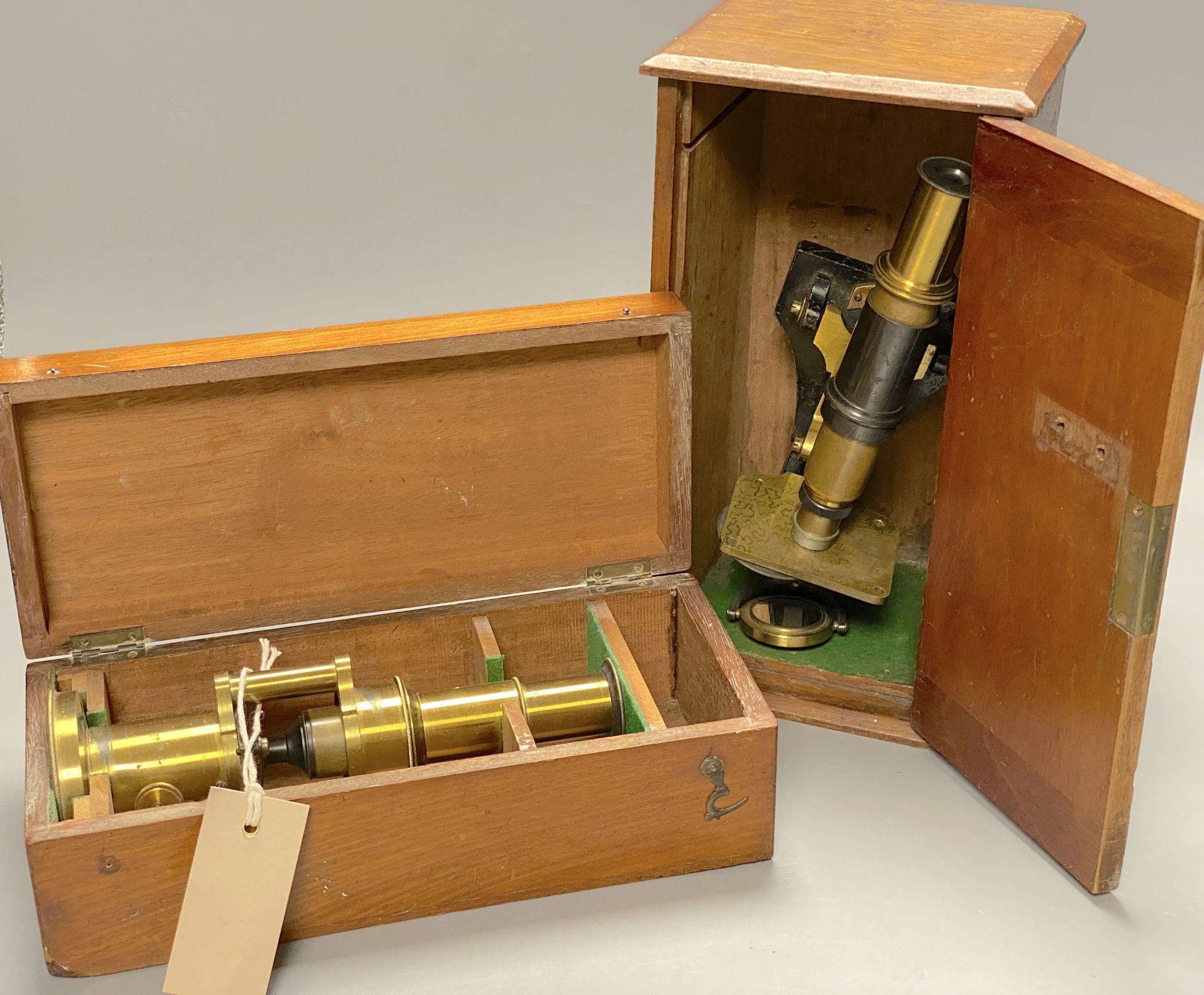 A hinge and wedge compound microscope by Parkes & Son, Birmingham and a lacquered brass students microscope, H 27cm (max); H 21cm